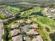 Aerial view showcasing a housing development by a golf course and ponds at 1154 Jameson Greens N Dr # 20, Sun City Center, FL 33573