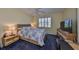 Comfortable bedroom with a ceiling fan, window, and neutral color scheme at 1154 Jameson Greens N Dr # 20, Sun City Center, FL 33573