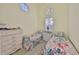 Comfortable guest bedroom featuring twin beds with floral bedding, white dressers, and natural light at 1154 Jameson Greens N Dr # 20, Sun City Center, FL 33573