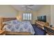 Bedroom featuring a ceiling fan, window with shutters, and a dresser at 1154 Jameson Greens N Dr # 20, Sun City Center, FL 33573