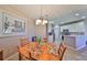 Cozy dining area featuring a wooden table with seating for four, next to a modern, bright kitchen at 1154 Jameson Greens N Dr # 20, Sun City Center, FL 33573