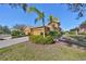 Charming home featuring a two-car garage, well-maintained landscaping, and decorative palm trees at 1154 Jameson Greens N Dr # 20, Sun City Center, FL 33573