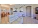 Open-concept kitchen with white cabinetry, stainless steel appliances, and a breakfast bar connecting to the living area at 1154 Jameson Greens N Dr # 20, Sun City Center, FL 33573