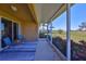 Screened patio with seating offers beautiful views of the green backyard and serene pond at 1154 Jameson Greens N Dr # 20, Sun City Center, FL 33573