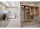 Luxurious bathroom and closet with a modern soaking tub and custom shelving at 118 Waterberry Dr, Tarpon Springs, FL 34688