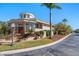 Striking home exterior with a turret, manicured lawn, and tropical landscaping on a sunny day at 118 Waterberry Dr, Tarpon Springs, FL 34688