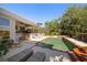 An in-ground pool is surrounded by a beautiful outdoor patio space with lounge chairs and lush landscaping at 118 Waterberry Dr, Tarpon Springs, FL 34688