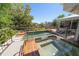 An inviting pool and spa combo with brick trim, providing a luxurious backyard experience at 118 Waterberry Dr, Tarpon Springs, FL 34688