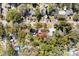 An aerial view of a home with mature trees on a quiet neighborhood street, property lines outlined in red at 1212 E Crawford St, Tampa, FL 33604