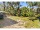 Spacious backyard surrounded by lush greenery and a wooden fence at 1212 E Crawford St, Tampa, FL 33604