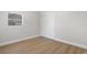 Bedroom features wood-look floors, a window, and a closet at 1212 E Crawford St, Tampa, FL 33604