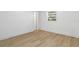 Clean bedroom with wood-look floors, natural light, and neutral color palette at 1212 E Crawford St, Tampa, FL 33604