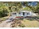 Charming single-story home featuring a well-manicured lawn, mature shade trees, and an inviting front entrance at 1212 E Crawford St, Tampa, FL 33604