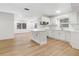 Bright kitchen featuring white cabinets and countertops, stainless steel appliances, and eat-in island at 1212 E Crawford St, Tampa, FL 33604