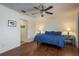 Cozy bedroom with ceiling fan, wood floors, and ensuite bathroom at 1275 Bayview Dr, Clearwater, FL 33756