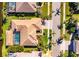 Aerial view of home showcasing pool, landscaping, and proximity to the water at 1335 Jumana Loop, Apollo Beach, FL 33572