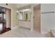 Bright bathroom with a shower and a vanity with a mirror at 1335 Jumana Loop, Apollo Beach, FL 33572