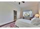 Comfortable bedroom with hardwood floors, view of the outdoors, and access to an ensuite bathroom at 1335 Jumana Loop, Apollo Beach, FL 33572