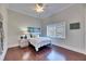 Cozy bedroom with hardwood floors, a ceiling fan, and a view of the outdoors at 1335 Jumana Loop, Apollo Beach, FL 33572