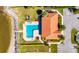 An aerial view showcases the pool next to a charming clubhouse and waterfront access at 1335 Jumana Loop, Apollo Beach, FL 33572