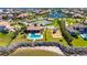 Aerial view of a community clubhouse, swimming pool, playground, tennis courts, and waterway access at 1335 Jumana Loop, Apollo Beach, FL 33572