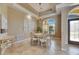 Dining area with a round table, chandelier, large window, and custom wall details at 1335 Jumana Loop, Apollo Beach, FL 33572