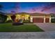 Charming home featuring manicured lawn, mature trees and three-car garage at 1335 Jumana Loop, Apollo Beach, FL 33572