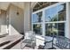 Inviting front porch with decorative chairs and large windows offering abundant natural light at 1335 Jumana Loop, Apollo Beach, FL 33572