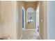 Bright hallway with tiled floors, neutral walls, and arched shelving at 1335 Jumana Loop, Apollo Beach, FL 33572