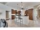 Kitchen island with dark wood cabinets, granite countertops, and seating for two at 1335 Jumana Loop, Apollo Beach, FL 33572