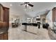 Open concept kitchen and living room with tile floors and stainless steel appliances at 1335 Jumana Loop, Apollo Beach, FL 33572