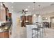 Kitchen with dark wood cabinets, granite countertops, stainless appliances and breakfast table at 1335 Jumana Loop, Apollo Beach, FL 33572