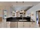 Kitchen island with granite countertop, stainless appliances and open layout to living room at 1335 Jumana Loop, Apollo Beach, FL 33572