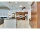 Bright, open kitchen with stainless appliances, wooden cabinetry, granite counters, and tile flooring at 1335 Jumana Loop, Apollo Beach, FL 33572