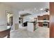 Open-concept layout with a modern kitchen, a dining area, and a living room with neutral colors and tile floors at 1335 Jumana Loop, Apollo Beach, FL 33572