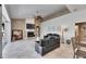 A large living room featuring high ceilings, tile flooring, comfortable seating, and a fireplace with a mounted television at 1335 Jumana Loop, Apollo Beach, FL 33572