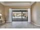 Spacious living area with tile flooring and a view of the outdoor pool and patio at 1335 Jumana Loop, Apollo Beach, FL 33572