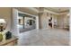 Bright living room featuring tile flooring, tray ceiling, and access to a private pool area at 1335 Jumana Loop, Apollo Beach, FL 33572