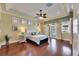 Bright main bedroom featuring wood floors, ensuite bath, and pool access at 1335 Jumana Loop, Apollo Beach, FL 33572