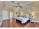 Primary bedroom with tray ceiling, wood floors, and bright natural light at 1335 Jumana Loop, Apollo Beach, FL 33572
