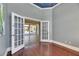 Home office with hardwood floors and doorway to outdoor pool area at 1335 Jumana Loop, Apollo Beach, FL 33572