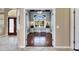 A cozy office with custom built-in shelves, wood floors, and natural light at 1335 Jumana Loop, Apollo Beach, FL 33572