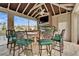Outdoor kitchen with bar seating, built-in grill, and TV, perfect for lakeside entertaining and relaxation at 1335 Jumana Loop, Apollo Beach, FL 33572