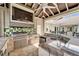 This outdoor kitchen features a built-in grill, sink, TV and plenty of counter space for entertaining at 1335 Jumana Loop, Apollo Beach, FL 33572