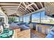 Outdoor kitchen with a built-in bar, sink, stainless steel mini-fridge, and views of the water at 1335 Jumana Loop, Apollo Beach, FL 33572