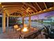 Relax in this covered outdoor living area with a fire pit and views of the water at 1335 Jumana Loop, Apollo Beach, FL 33572