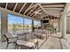Relaxing covered patio boasts comfortable seating and beautiful lake views, creating an ideal outdoor living space at 1335 Jumana Loop, Apollo Beach, FL 33572