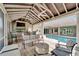 Enjoy this covered outdoor living space with a pool, seating, grill, tv, and stunning stone and stucco design at 1335 Jumana Loop, Apollo Beach, FL 33572