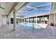 Inviting pool area with a covered patio, outdoor bar, and clear blue water at 1335 Jumana Loop, Apollo Beach, FL 33572