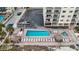 Aerial view of community pool and beach with lounge chairs at 13500 Gulf Blvd # 505, Madeira Beach, FL 33708